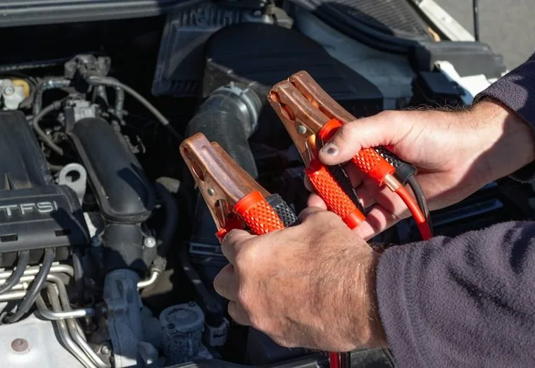 jump leads on a battery, hands only