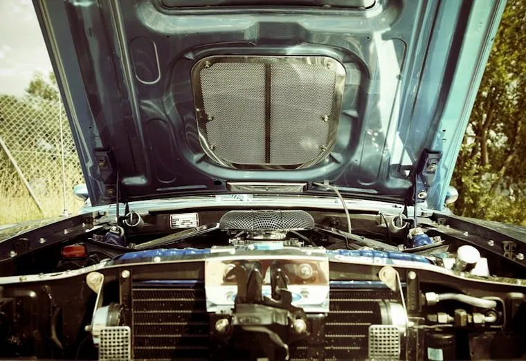 a mobile mechanic job — hands at work or a car with its bonnet up