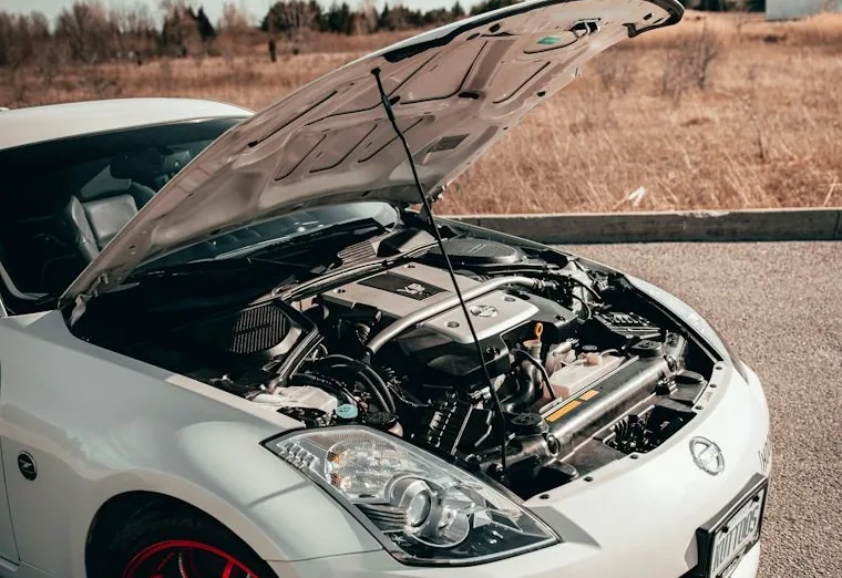 a mobile mechanic job — hands at work or a car with its bonnet up