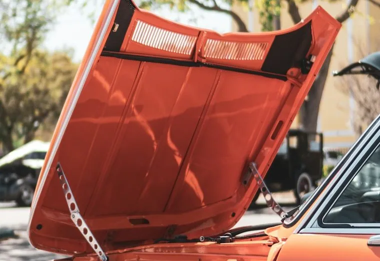 a mobile mechanic job — hands at work or a car with its bonnet up