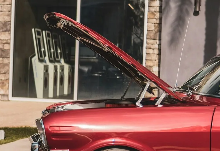 a mobile mechanic job — hands at work or a car with its bonnet up