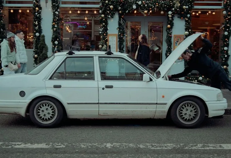 a mobile mechanic job — hands at work or a car with its bonnet up