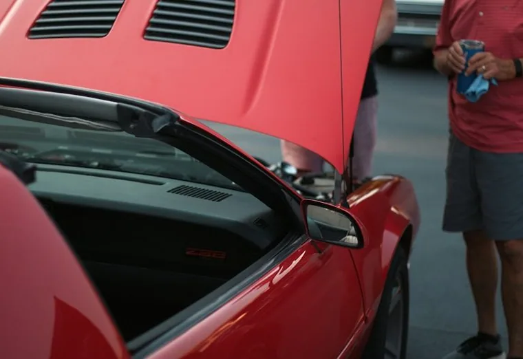 a mobile mechanic job — hands at work or a car with its bonnet up
